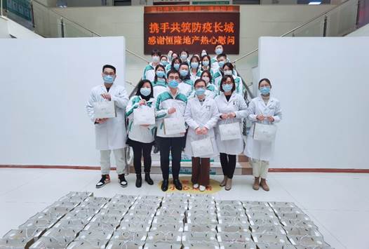 A group of people wearing white lab coats and masks
Description automatically generated with low confidence